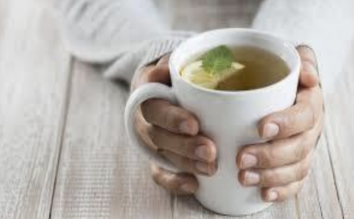 A Person Holding A Tea Cup