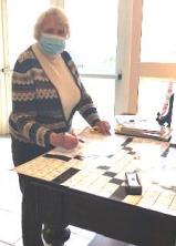 A Resident With A Mask On Playing A Game